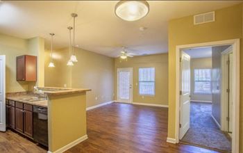 A kitchen with a counter and cabinets. at The Parker at Cone Apartments, Greenville, North Carolina